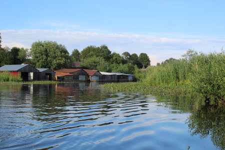 wooden garages for storing fishing boats on the river in the villageの写真素材