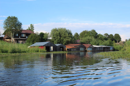 wooden garages for storing fishing boats on the river in the villageの写真素材