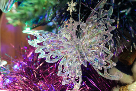 photo of a Christmas tree toy. New Year's beautiful decoration on the Christmas tree. beautiful butterfly made of plastic.の写真素材