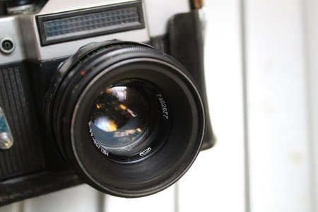 Vintage camera on white background, shallow depth of field, focus on lens