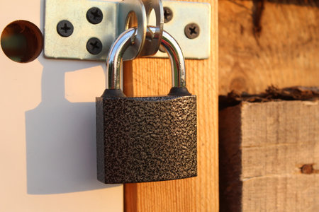 metal padlock on the door of a wooden shedの写真素材