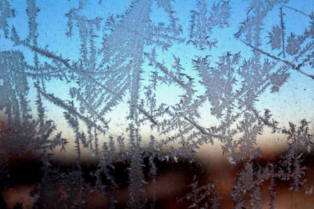 Frosty pattern on winter window glass. Abstract natural background.の写真素材