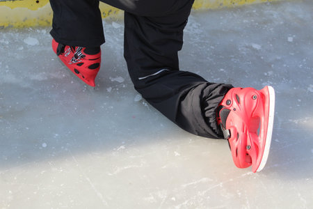 feet of a man skating on an ice rink, closeup of photoの写真素材