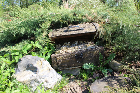 Wooden chest filled with stones in the garden on a sunny dayの写真素材