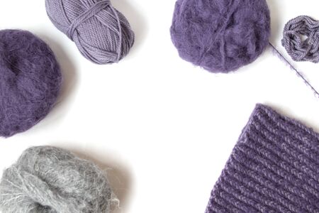 Purple woolen yarn balls on the white background. Isolated subjects. Copy space. Place for text and design. Top view. Flat layout. の写真素材
