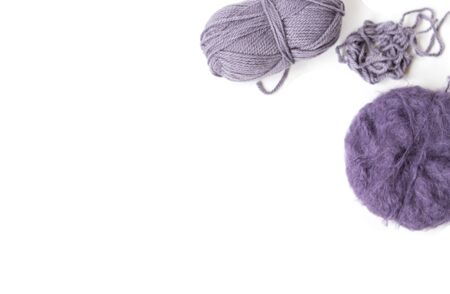 Purple woolen yarn balls on the white background. Isolated subjects. Copy space. Place for text and design. Top view. Flat layout. の写真素材