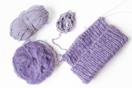 Purples yarn balls on the white background. Isolated objects. Top view. Flat layout. Knitting with pleasure. Future hat. の写真素材