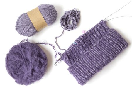 Purples yarn balls on the white background. Isolated objects. Top view. Flat layout. Knitting with pleasure. Future hat. の写真素材