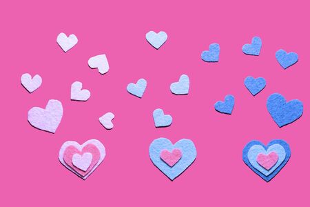 Colorful felt hearts on the pink background. Top view. Flat lay. Yellow hearts. Hand made decor.の写真素材