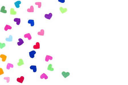 Colorful felt hearts on the white background. Copy space. Place for text and design. Hand made decor. Valentine's card.  Blue, yellow, pink, red, orange, purple, violet, green colors.の写真素材