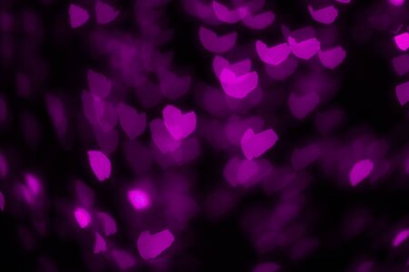 Pink hearts out of focus. Colorful lights. Dark background. Copy space. Place for text and design.の写真素材