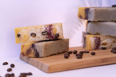Natural cosmetic on the wooden board. The shadow of the fern. Coffee beans. Hand made soap