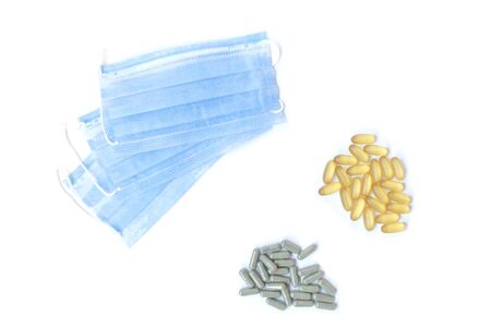 Masks and pills on the white backgroundの写真素材