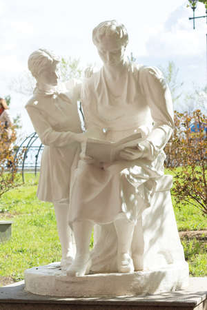 KHABAROVSK, RUSSIA - MAY 7, 2014: Statue of a woman with a girl reading a book in the park Alley sculpture. Alley opened in 2008 as part museum named after Grodekovのeditorial素材