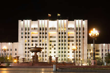 KHABAROVSK, RUSSIA - MAY 16, 2014: The central part of the administration building with night illumination. The roof is decorated with two flags: the Russian flag and the flag of Khabarovsk Kraiのeditorial素材
