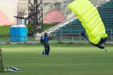 TVER, RUSSIA - AUGUST 2, 2015: Parachutist lands at the stadium Khimik during the celebration Day of the Airborne Forcesのeditorial素材