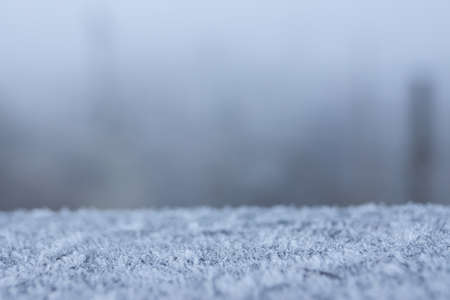 abstract background with a handrail in the frost and blurred railwayの写真素材
