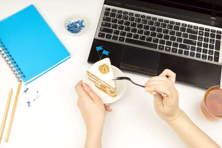 A person holding a piece of cake in the bowl and a teaspoon.
