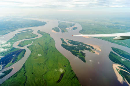 View of the Amur River from the window of a flying planeの写真素材