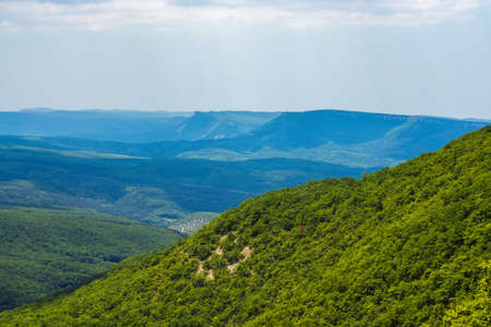 Slope of the hill and low mountains on a sunny summer dayの写真素材