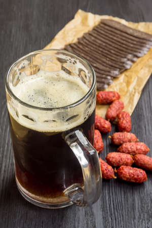 Mug of dark beer and snack - mini sausages and sudzhuk