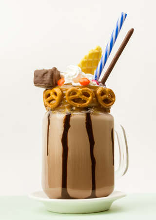 Chocolate freakshake with waffles, biscuits and sweets in a jarの写真素材