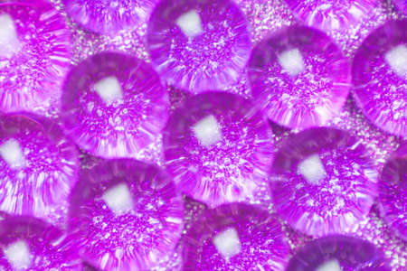 Abstract background of sparkles translucent through purple hydrogel balls