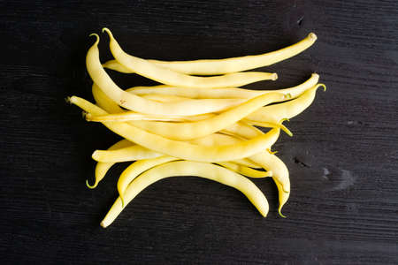 Yellow bean pods (haricot) on a wooden table, legumes harvestの写真素材