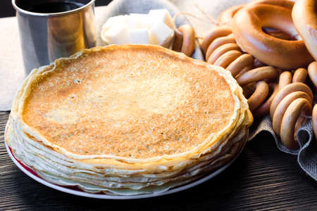 Shrovetide Maslenitsa festival. Table with pancakes (blini), bagels (sushki and baranki) and tea.の写真素材