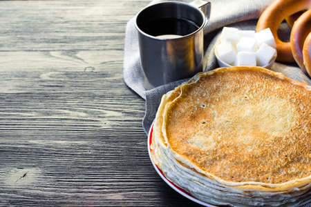 Shrovetide Maslenitsa festival. Table with pancakes (blini), bagels (sushki and baranki) and tea.の写真素材