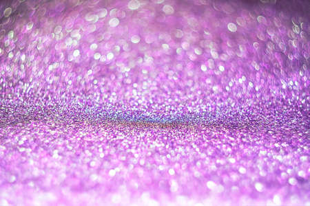 Bright festive background with sparkles and bokeh. Purple backdrop of celebration. New year or Christmasの写真素材
