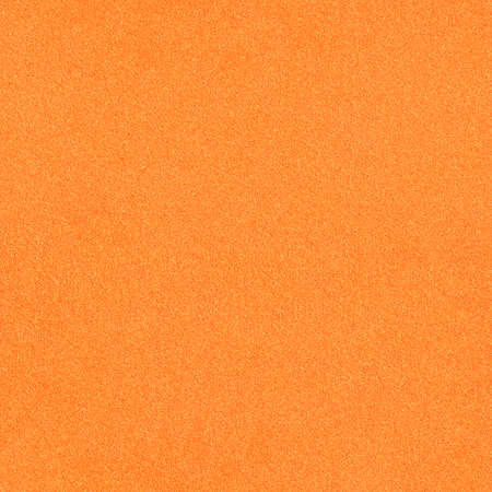 The surface texture of foamiran. Orange synthetic sponge material. Bright foam rubber backgroundの写真素材