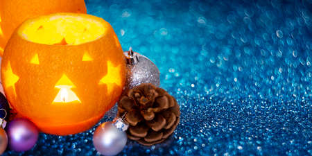 Beautiful Christmas background with orange peel candlesticks and balls. Celebrating New Year. Sparkle bokehの写真素材