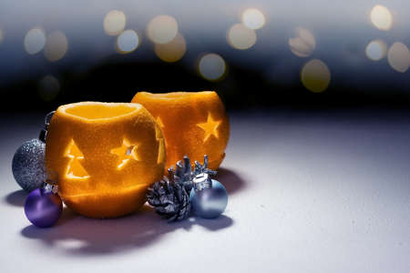 New Year composition with orange candlesticks and decorative balls on bokehの写真素材