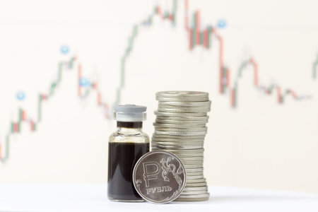 Ruble coins and a bottle of crude oil against the background of a price chart. The description on the coin - rubleの写真素材