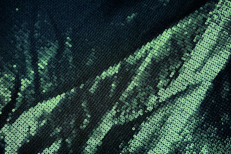 Green sequin, metallic fabric texture background.の写真素材