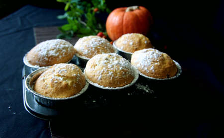 Homemade Lemon muffins in baking dish close up on black background.の写真素材
