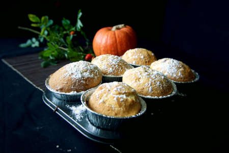 Homemade Lemon muffins in baking dish close up on black background.の写真素材