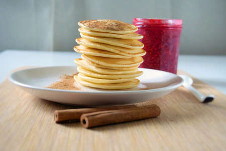 Homemade sweet pancakes with raspberries jam on a plate.の写真素材