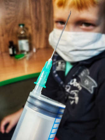 a child wearing a mask came for vaccination vaccination at a doctor's appointment
