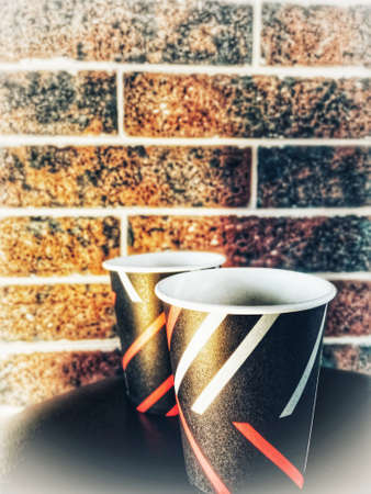 coffee cups on brick wall background