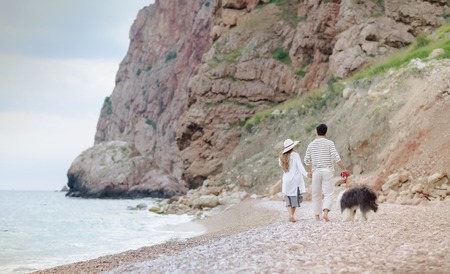 Happy young couple having beach fun on vacation honeymoon travel holidays.の写真素材