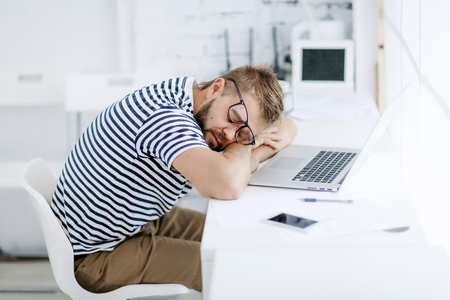 Successful businessman. Sleep office worker. Portrait of bearded businessman. Serious businessman. Man standing at table and holds laptop. Handsome bearded office worker.の写真素材