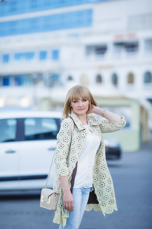 Fashion portrait of pretty hipster blonde girl outdoors in sunny dayの写真素材