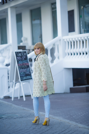 Fashion portrait of pretty hipster blonde girl outdoors in sunny dayの写真素材
