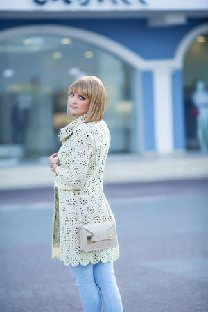 Fashion portrait of pretty hipster blonde girl outdoors in sunny dayの写真素材