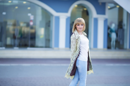 Fashion portrait of pretty hipster blonde girl outdoors in sunny dayの写真素材