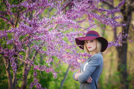 Young woman smiling on the red garden background, copy spaceの写真素材