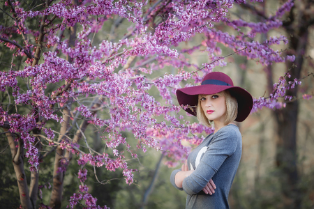 Young woman smiling on the red garden background, copy spaceの写真素材