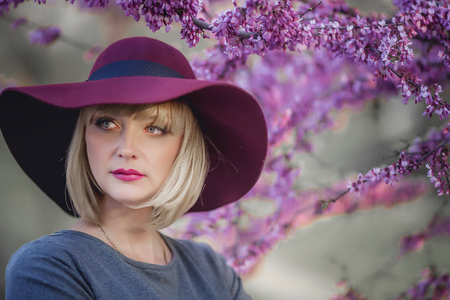 Young woman smiling on the red garden background, copy spaceの写真素材